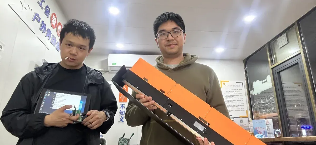 Two founders reviewing a prototype on a workbench